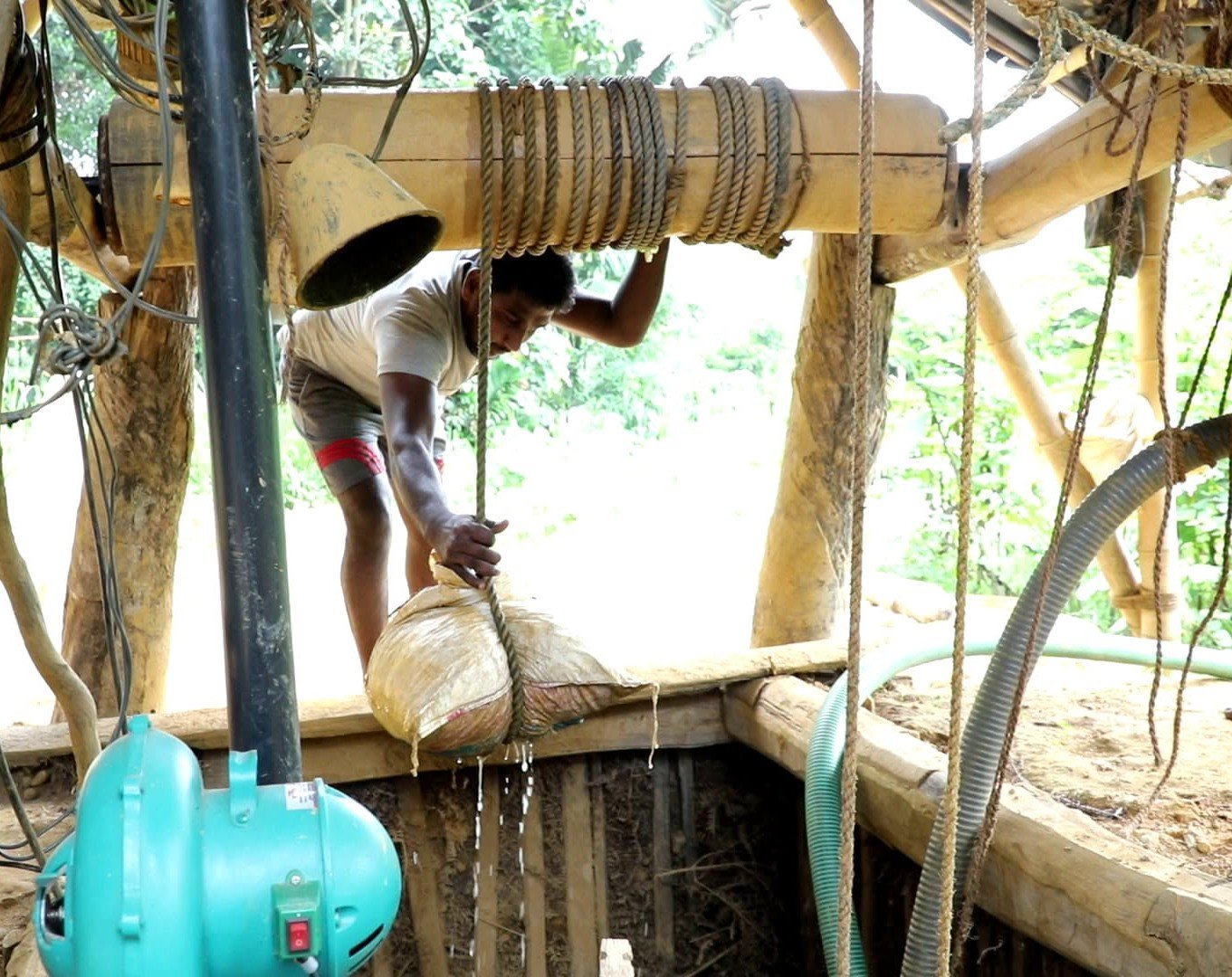 Wide view of a Sri Lankan sapphire mining pit showing the working environment